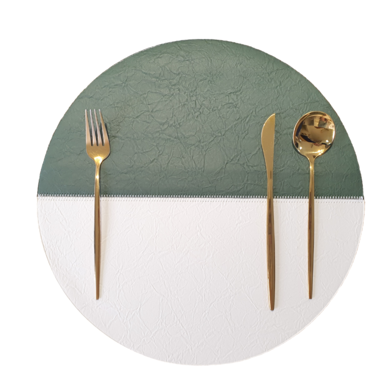 Round green and white placemat with cutlery